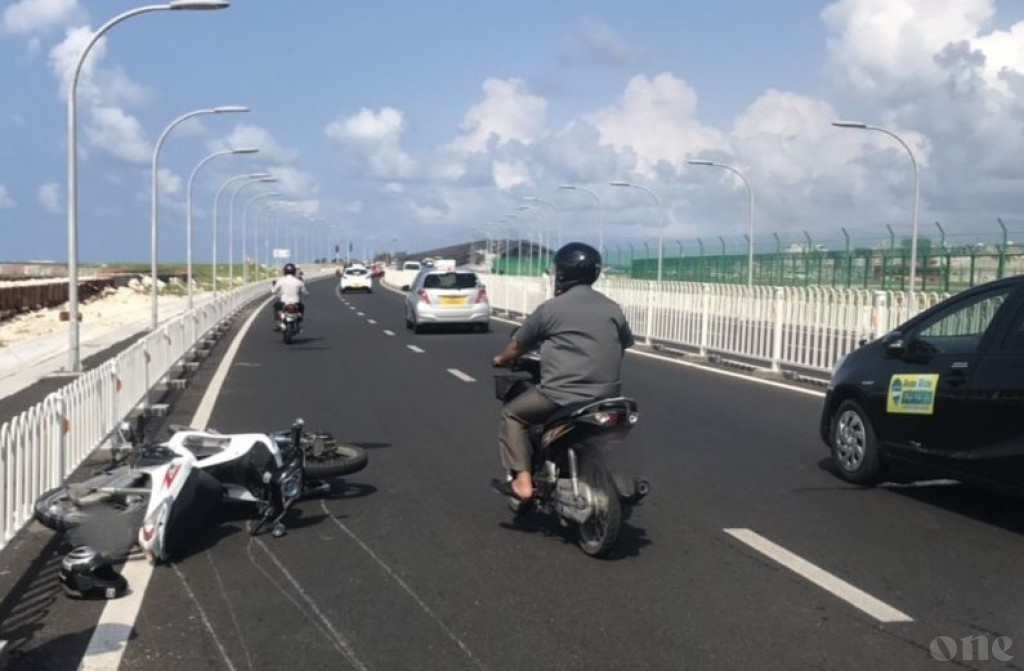Motorcycle skids on the bridge after hitting car and hits a second motorcycle