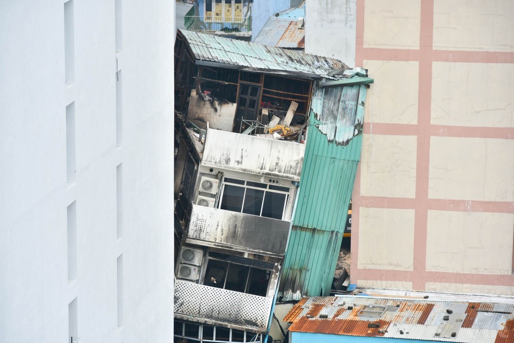 Building leaning after fire being torn down