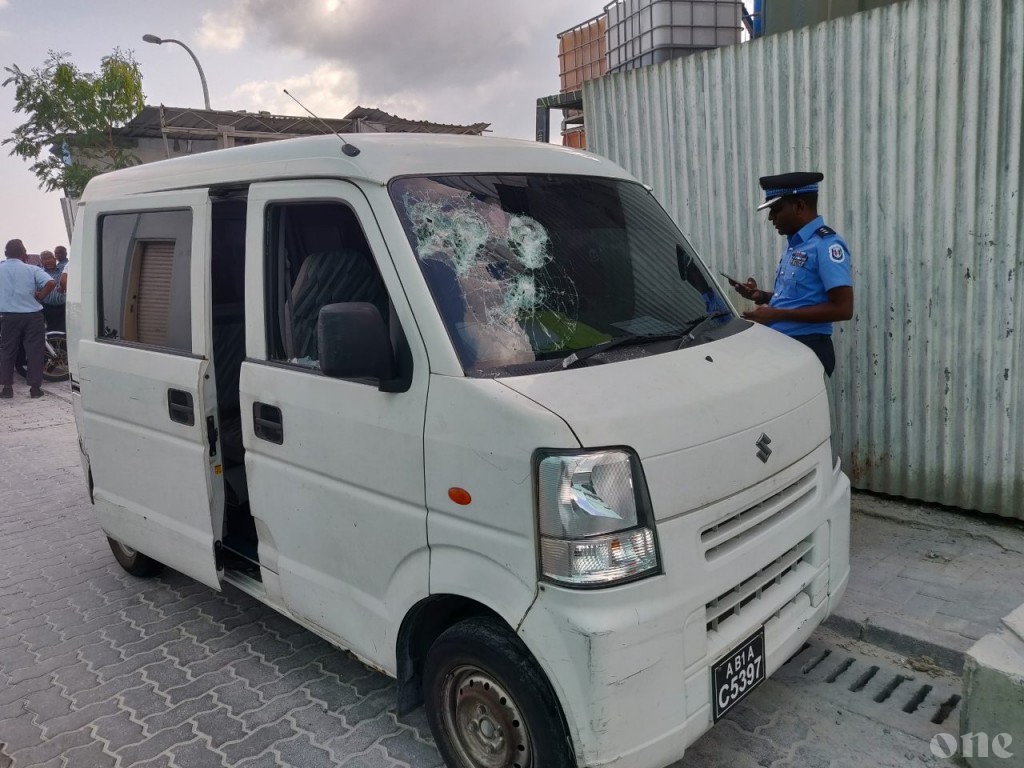 Van damaged after wall falls from the second floor of building