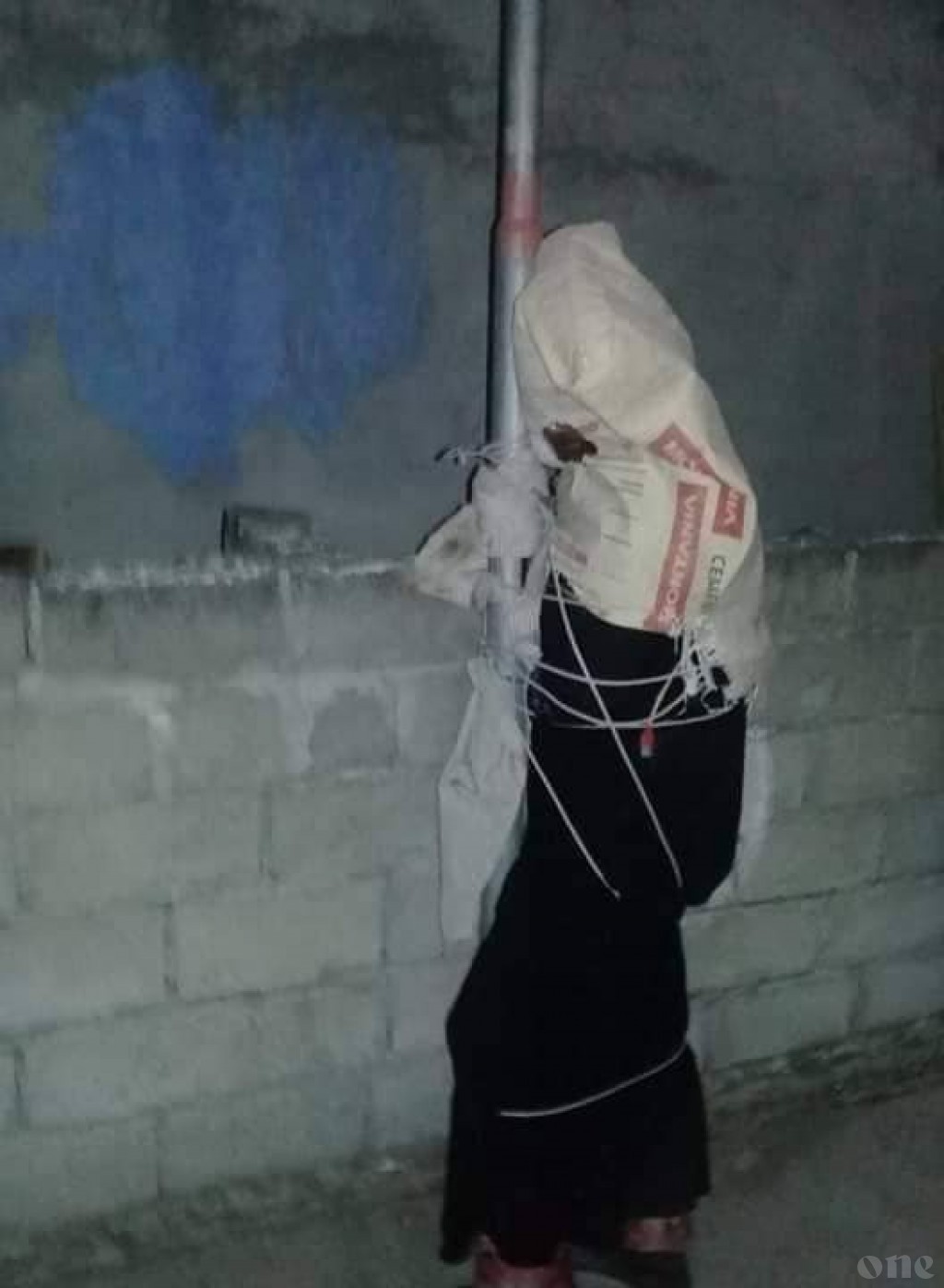 State takes custody of woman tied to lamp post along with her child