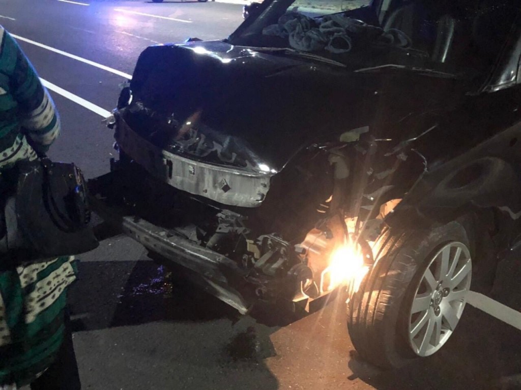 Car runs into highway fence following busted tire