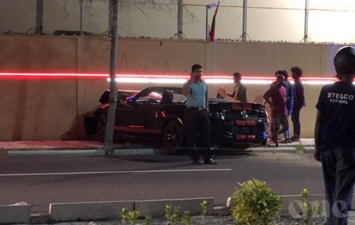 Speeding car loses control, hits wall
