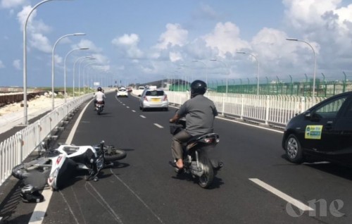 Motorcycle skids on the bridge after hitting car and hits a second motorcycle