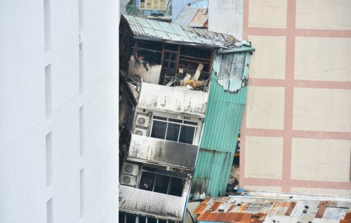 Building leaning after fire being torn down