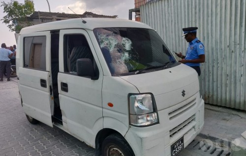 Van damaged after wall falls from the second floor of building