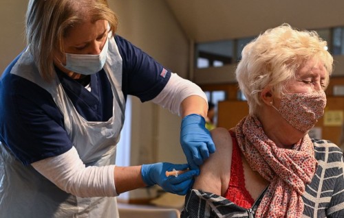 UK vaccination drive expands as COVID-19 toll nears 100,000