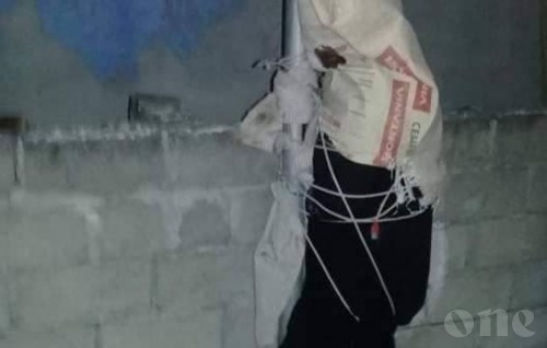 State takes custody of woman tied to lamp post along with her child