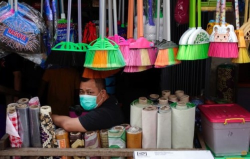 Indonesia extends COVID-19 curbs as infections spread in regions
