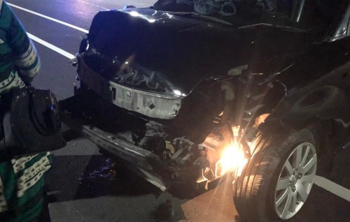 Car runs into highway fence following busted tire